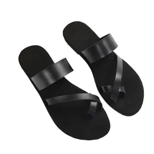 Minimalist black women's toe loop flip-flops with flat soles for casual beach wear
