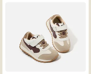 Detailed side view of stylish beige and brown baby sneakers with secure velcro straps.