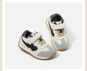 Detailed top view of cream and grey toddler sports shoes with heart pattern design