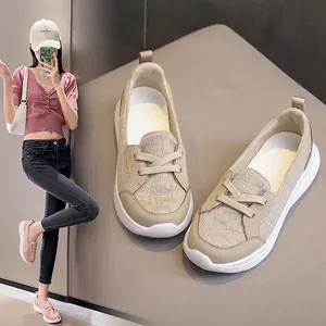 Detail view showcasing beige outdoor slip-on loafers alongside a model in a pink pair