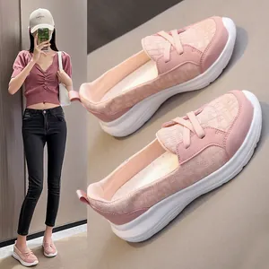 Detail view of pink slip-on loafers for women with chunky white platform soles.