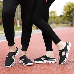 Close-up of breathable black mesh casual half-slippers worn on an outdoor track
