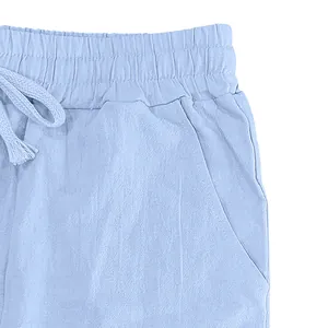 Close-up detail of light blue men's breathable cotton linen pants with elastic waist.