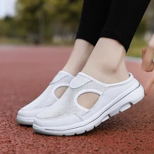 Detailed view of white breathable mesh slip-on casual shoes on a running track