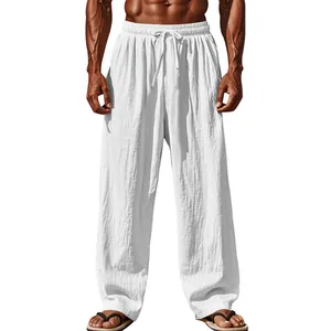 Detailed view of white loose-fitting cotton linen trousers with drawstring elastic waist.