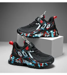 Boys' breathable mesh sports shoes with vibrant graffiti-patterned soles on display.