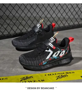 Close-up of black breathable mesh boys' running shoes with graffiti detail
