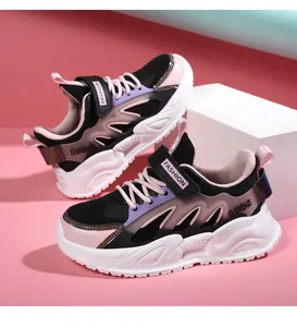 Detailed side view of pink and black breathable mesh girls sneakers on pink background