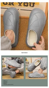 Close-up of grey plush-lined slippers with embossed leaf pattern in a cozy home setting