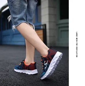Dettaglio del tessuto a rete traspirante sulle sneakers da bambino blu e arancioni vivaci.