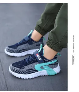 Detailed side view of breathable blue fly-knit running sneakers for boys on foot