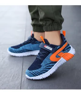 Detailed view of breathable blue fly-woven boys sports shoes with orange accents