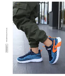 Close-up of lightweight blue fly-knit running shoes for boys on outdoor pavement