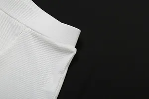 Dettaglio ravvicinato del tessuto a coste bianco e della vita elastica degli shorts a vita alta