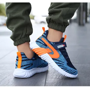 Detailed view of breathable fly-knit sports running shoes for boys in blue and orange colors.