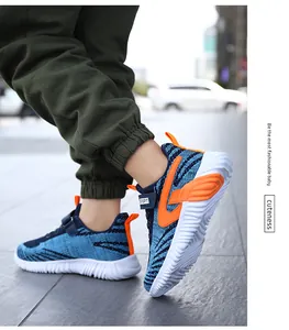 Detailed side view of boys' blue and orange breathable mesh sneakers in outdoor action.