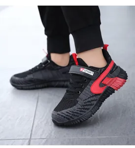 Macro view of boys' breathable fly-knit sports running shoes with red stripe detail
