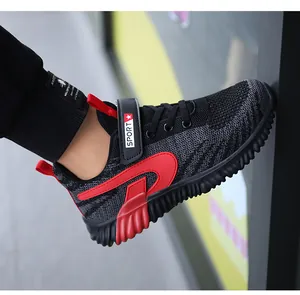 Detailed side view of lightweight black and red knit mesh boys' sports running shoes