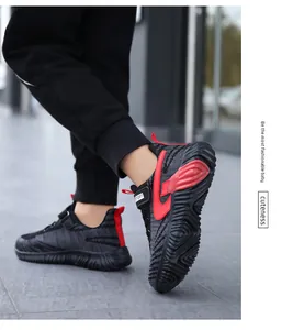 Close-up detail of stylish breathable fly-knit boys' running sneakers in black and vibrant red