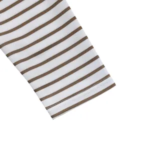Close-up of brown horizontal stripes and piqué fabric texture on T-shirt sleeve.