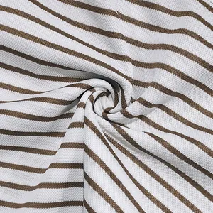 Macro view of soft piqué cotton fabric showing brown and white striped texture pattern