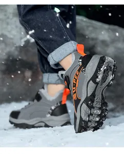Close-up detail of children's warm winter hiking shoes with non-slip soles in snow