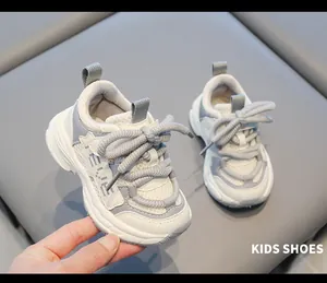 Close-up detail of toddler gray and white mesh sneakers with soft non-slip rubber soles