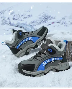 Detailed view of children's warm hiking boots with thick fur lining in the snow