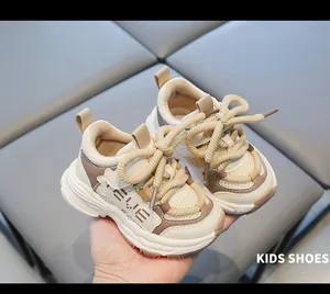 Close-up macro view of beige toddler chunky sneakers with soft soles and mesh texture