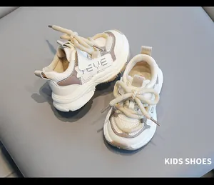 Detailed view of stylish cream and taupe toddler walking shoes with soft mesh panels