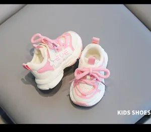 Close-up of pink and white toddler sports sneakers with soft non-slip soles