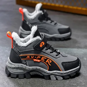 Grey winter children's hiking shoes with thick white fur lining and orange accents