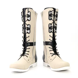 Detailed view of cream and black vintage lace-up tall boots with stylish metal hardware