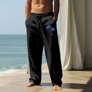 Loose black cotton linen casual pants for men featuring a blue palm tree print detail