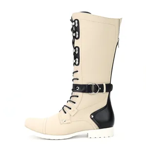 Side view of vintage men's cream and black tall motorcycle boots with laces