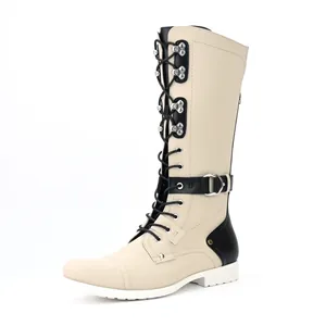 Close-up detail view of vintage men's knee-high motorcycle boots in cream and black tones
