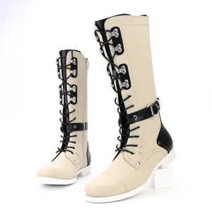 Vintage men's motorcycle boots with lace-up front and buckle details in beige.