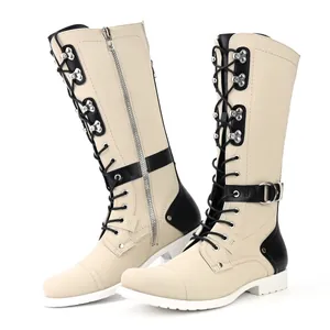 Side view of beige and black motorcycle boots with metallic rivets and lace-up front