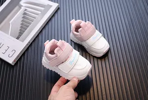 Detailed view of pink and white toddler sneakers featuring waterproof leather upper