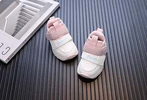 Close-up of stylish pink and white toddler walking sneakers with waterproof leather finish