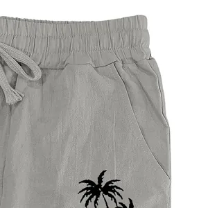 Close-up of breathable cotton linen pants with elastic waist and palm tree print