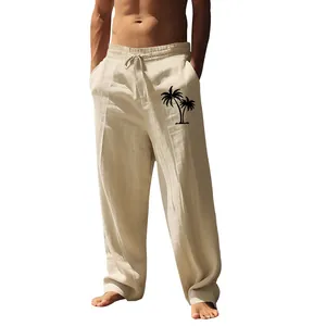 Detailed view of men's loose beige cotton linen trousers featuring black palm tree print
