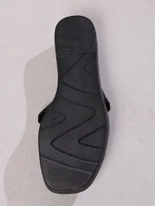 Close-up of black anti-slip textured sole for summer wedge sandals size thirty-seven