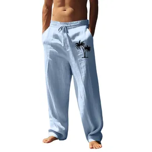 Detail of light blue men's linen pants featuring a black palm tree print.