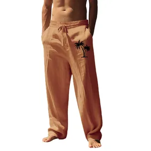 Detail of men's brown linen trousers with coconut tree print and drawstring waist