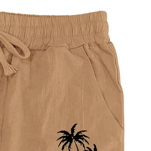 Detailed view of men's cotton linen pants with elastic waist and palm tree print