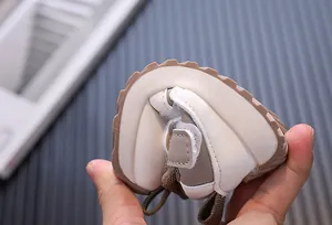 Close-up view showing the flexible and soft sole of a toddler walking shoe for babies.