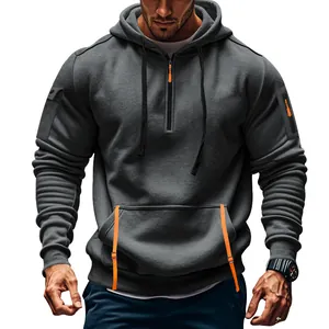 Detail view of men's dark grey pullover hoodie with orange zipper pulls and arm pocket