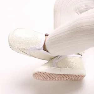 Macro detail shot showing the sparkling finish of white PU soft sole baby pre-walker shoes