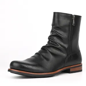 Close-up shot of men's black pleated casual short boots featuring a side zipper design